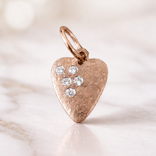Heart-shaped 14k rose gold pendant with embedded natural diamonds on a soft beige background - perfect for valentines day gift
