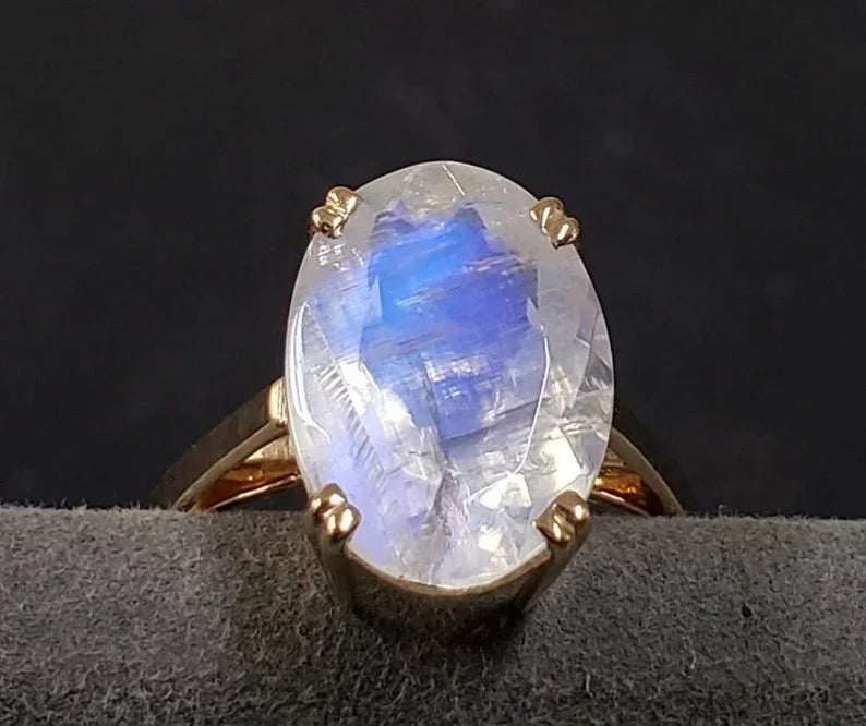 Oval moonstone ring in gold setting with blue adularescence, elegant jewelry accessory