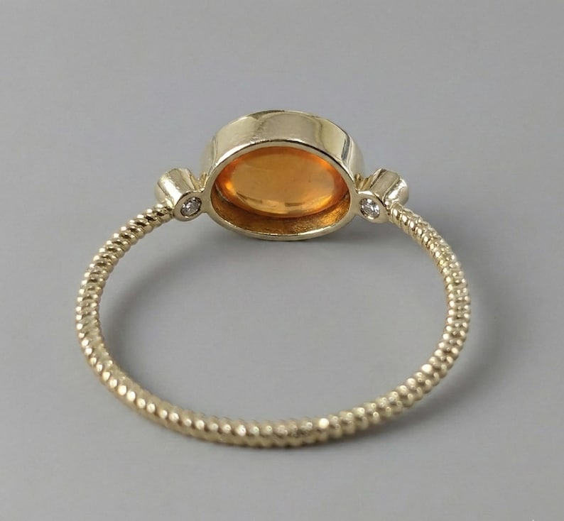 Handmade carnelian spiral ring worn on the hand