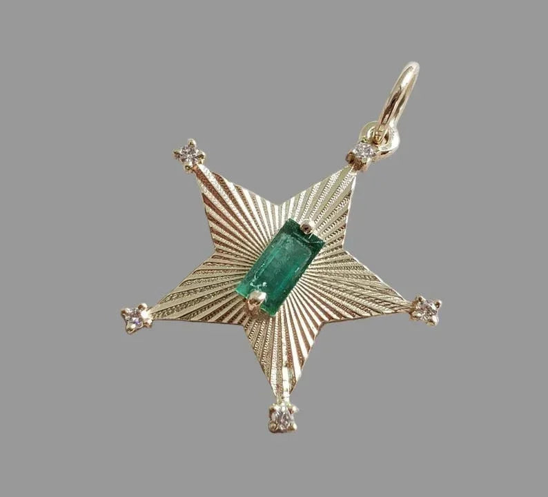 Gold star pendant with emerald center and diamond accents, elegant jewelry accessory