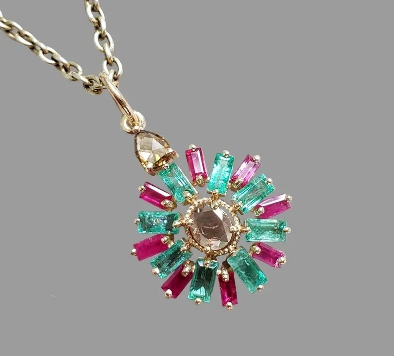 Elegant gold pendant with emerald and ruby gemstones, perfect for luxury jewelry lovers