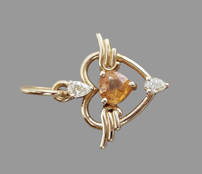 Handmade orange sapphire heart charm, side view