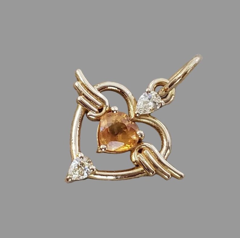 Heart sapphire pendant in golden orange, close-up