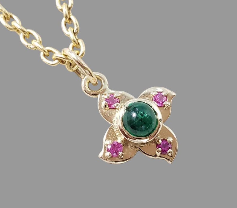 Dainty emerald and ruby flower charm, side view
