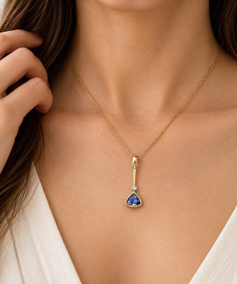Dainty sapphire charm in yellow gold, front view