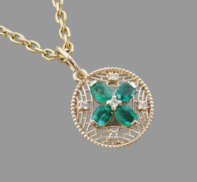 Emerald flower pendant with four Zambian emeralds in 14K gold