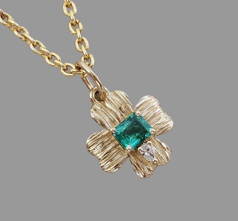 Emerald floral pendant in textured 14K gold with diamonds