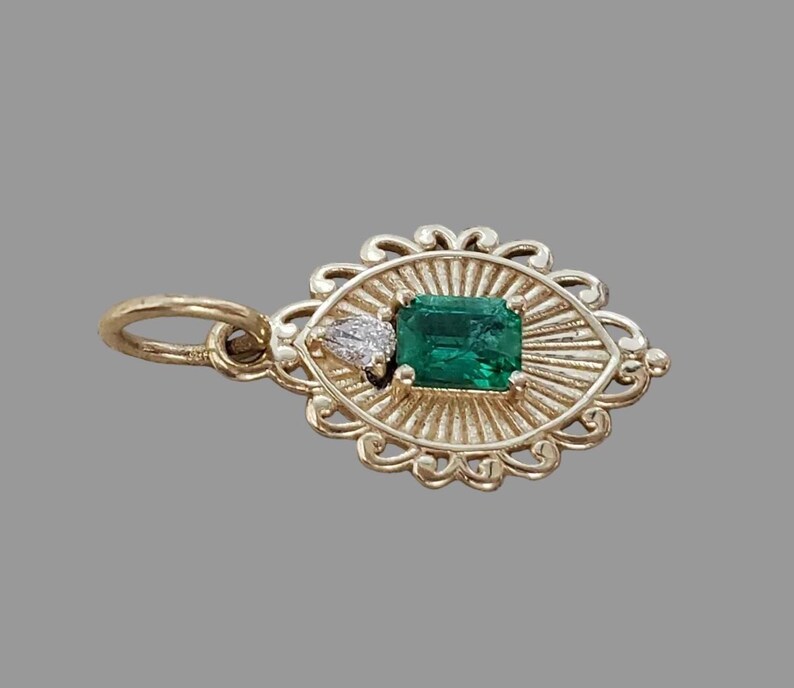 Emerald diamond charm with textured gold sunburst rays