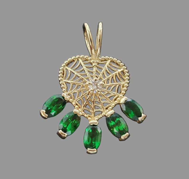 Tsavorite pendant in a 14K gold spider web design