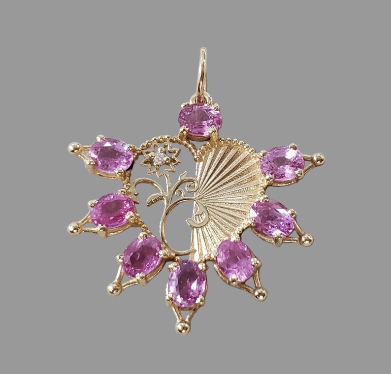 Statement gold pendant with oval pink sapphires, close-up