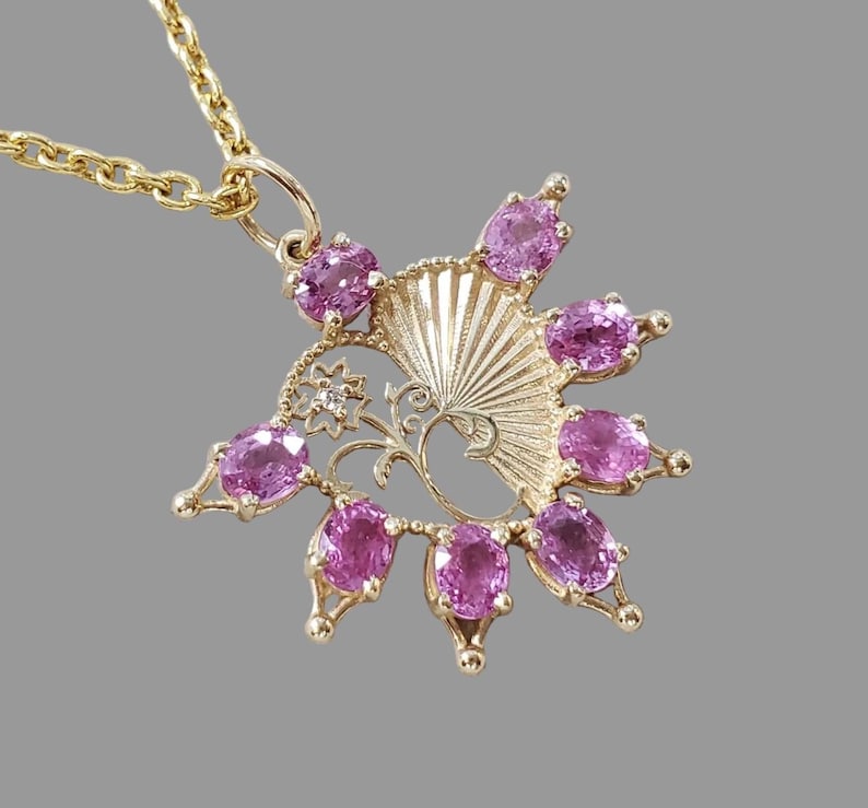 Pink sapphire pendant in an ornate 14K gold fan design