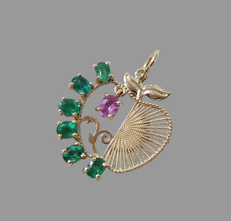 Gold apple charm set with natural green emeralds