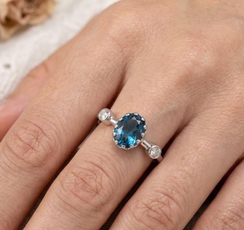 Platinum gemstone ring with deep blue topaz, close-up
