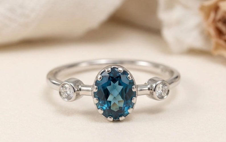 London blue topaz ring with oval stone and diamonds in 950 platinum