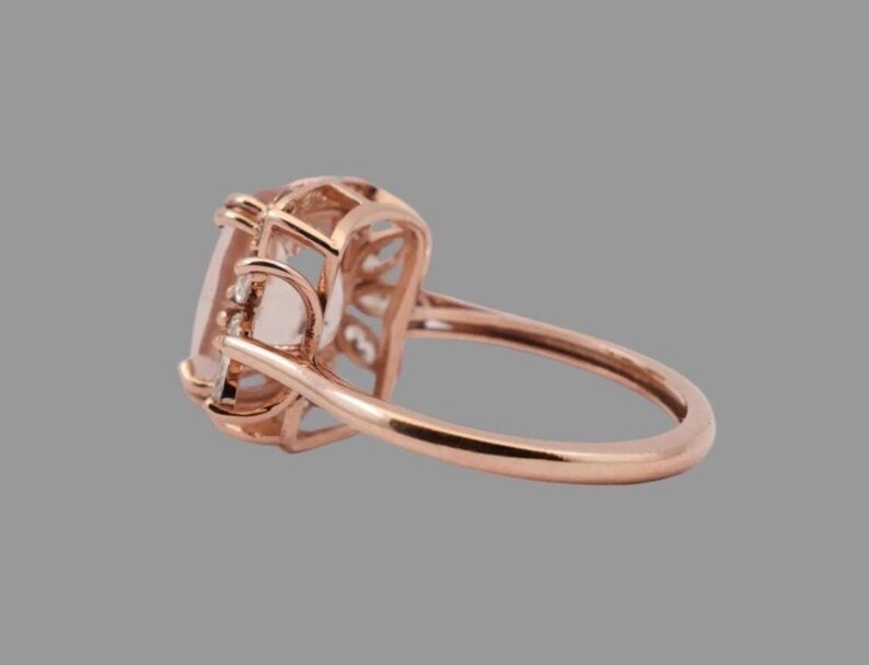 Handmade peach morganite and diamond ring on the hand