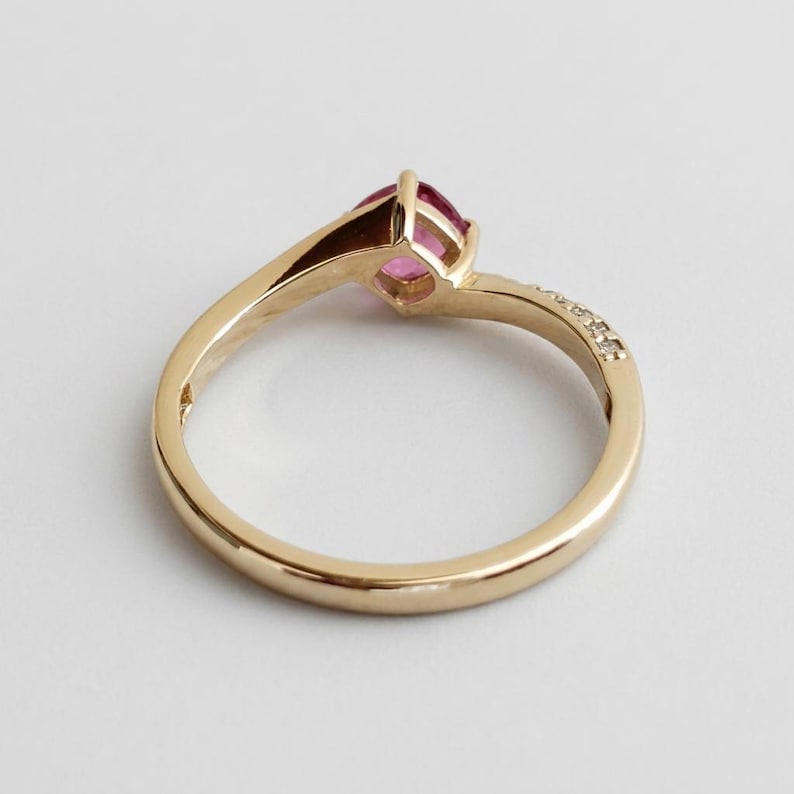 Handmade padparadscha ring worn on the hand
