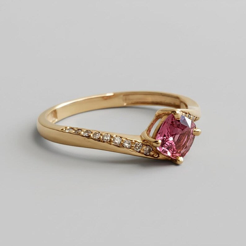 Pink-peach padparadscha sapphire and diamond ring, close-up