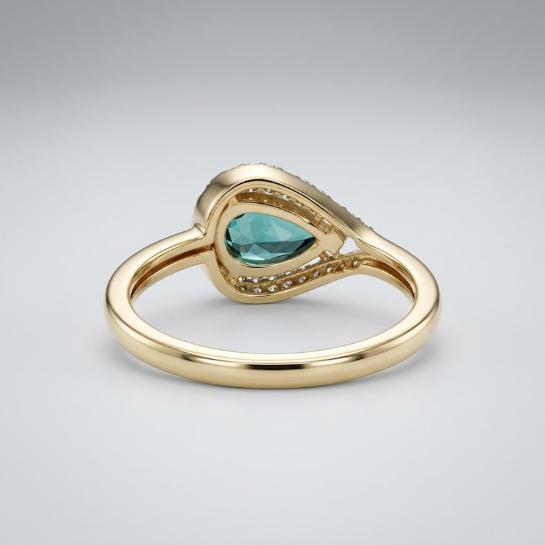 8 x 5 mm blue spinel engagement-style ring with diamond halo