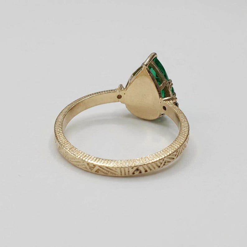 Emerald engagement ring with Art Deco engraved shank