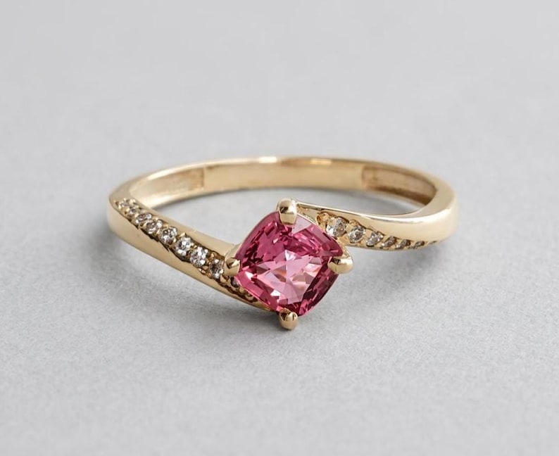 Padparadscha sapphire ring with cushion stone on 14K gold bypass band