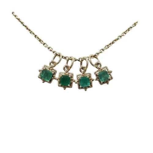 Elegant gold necklace with four square emerald charms, perfect for sophisticated jewelry lovers