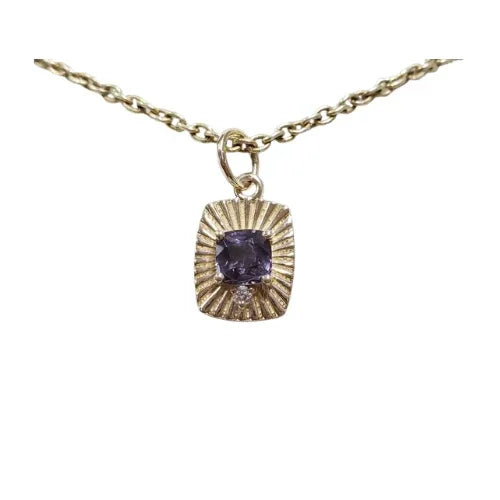 Elegant gold necklace with cushion-cut purple gemstone pendant, radiant sunburst design, fine jewelry