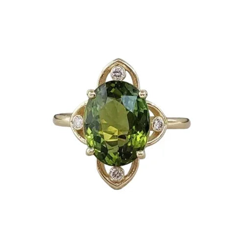 Elegant gold ring with oval green gemstone and diamond accents, luxury jewelry design