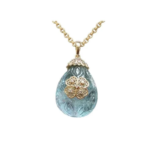 Elegant gold and diamond flower pendant on a blue gemstone necklace