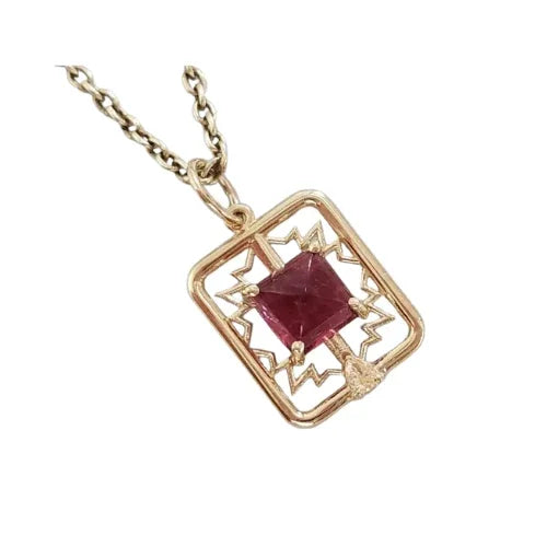 Elegant gold pendant with square ruby gemstone, intricate geometric design, perfect for luxury jewelry lovers