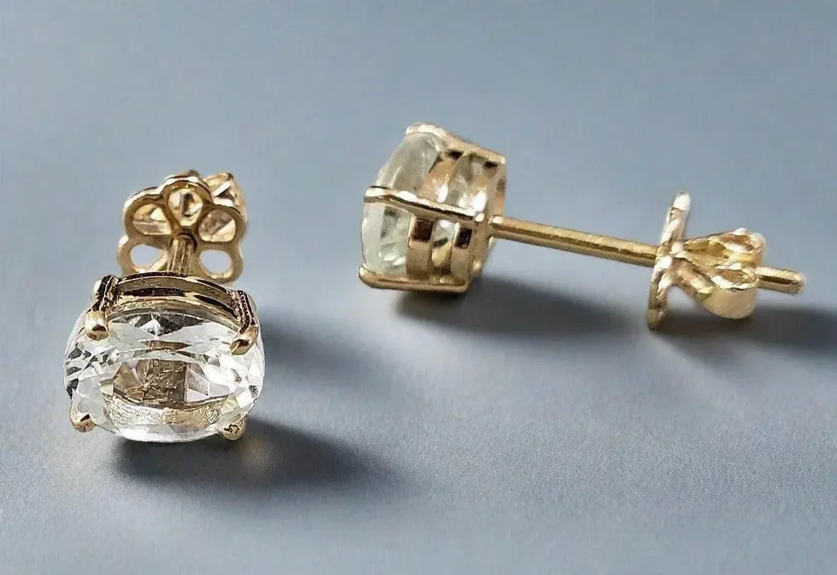 Elegant gold stud earrings with clear oval gemstones, perfect for sophisticated jewelry lovers