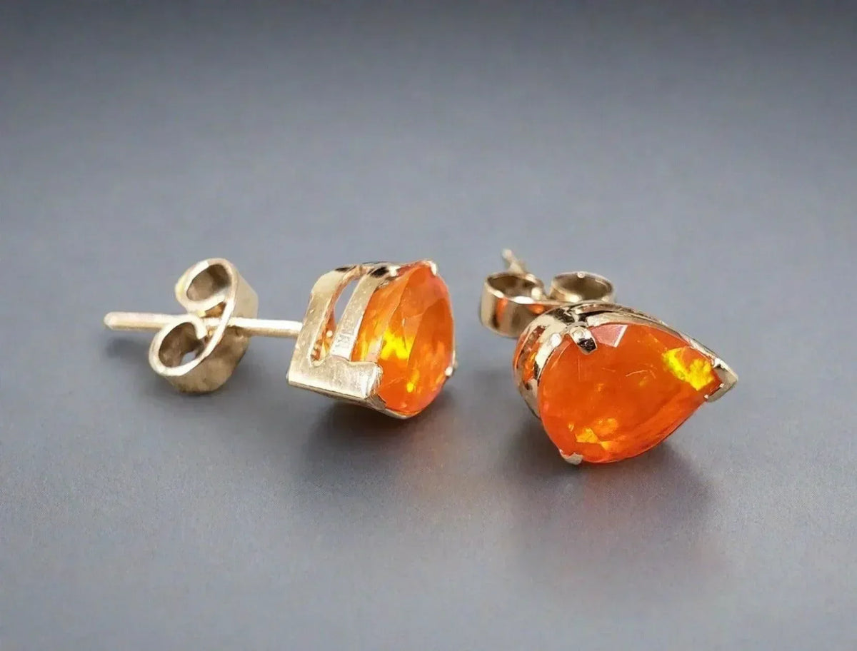 Gold stud earrings with vibrant orange pear-shaped gemstones, elegant jewelry accessory
