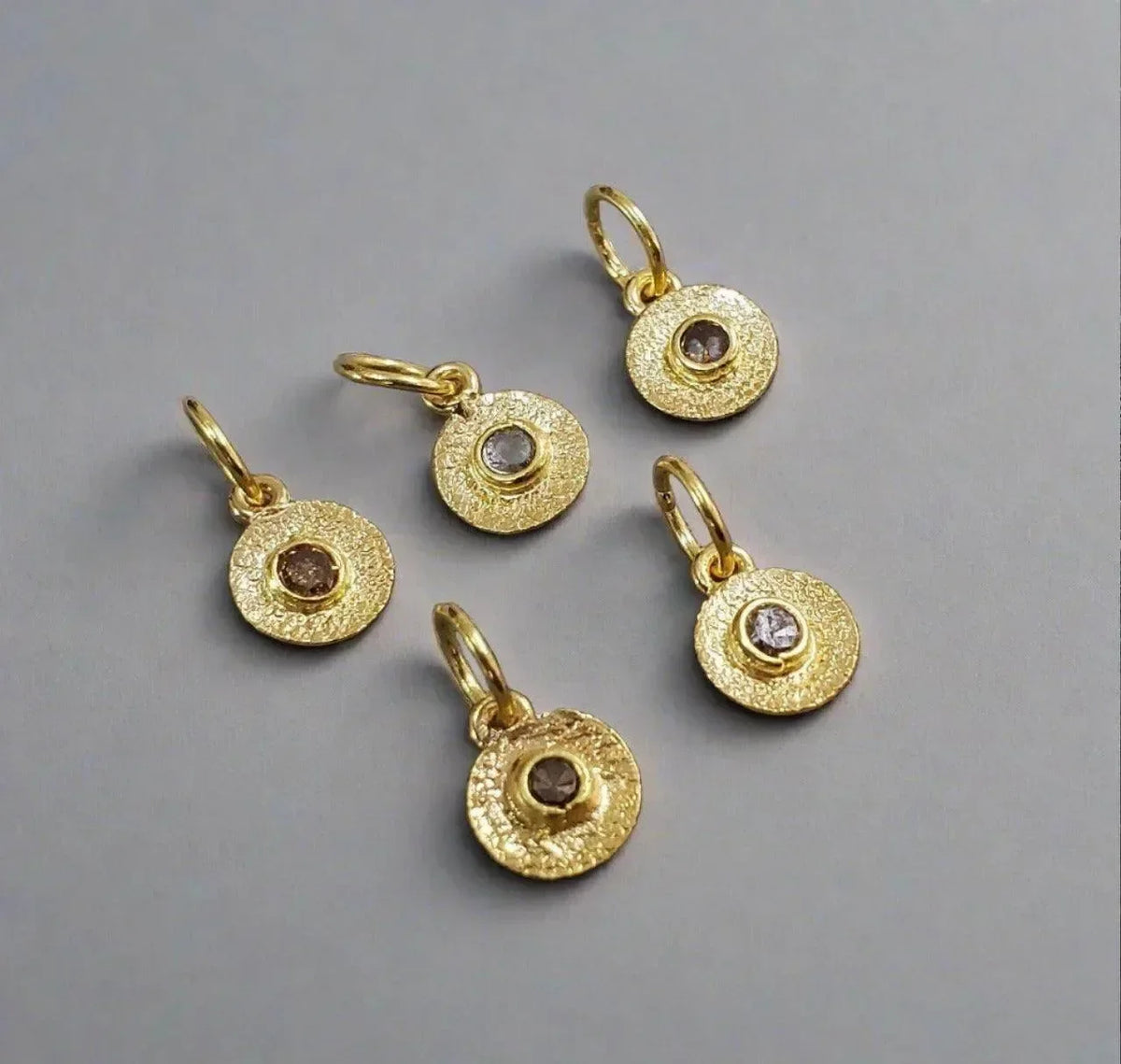 Textured gold disc charms with diamond centers, elegant jewelry accessories