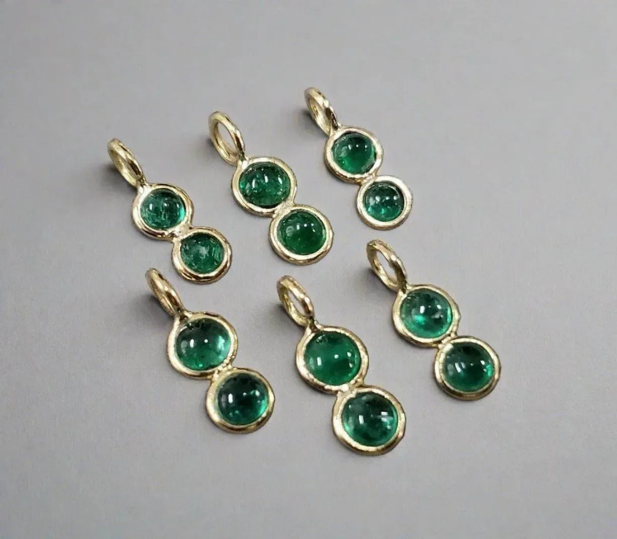 Gold double emerald gemstone pendants, elegant jewelry accessories with vibrant green stones