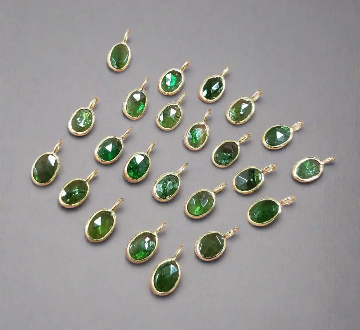 Oval green gemstone pendants in gold settings, elegant jewelry accessories