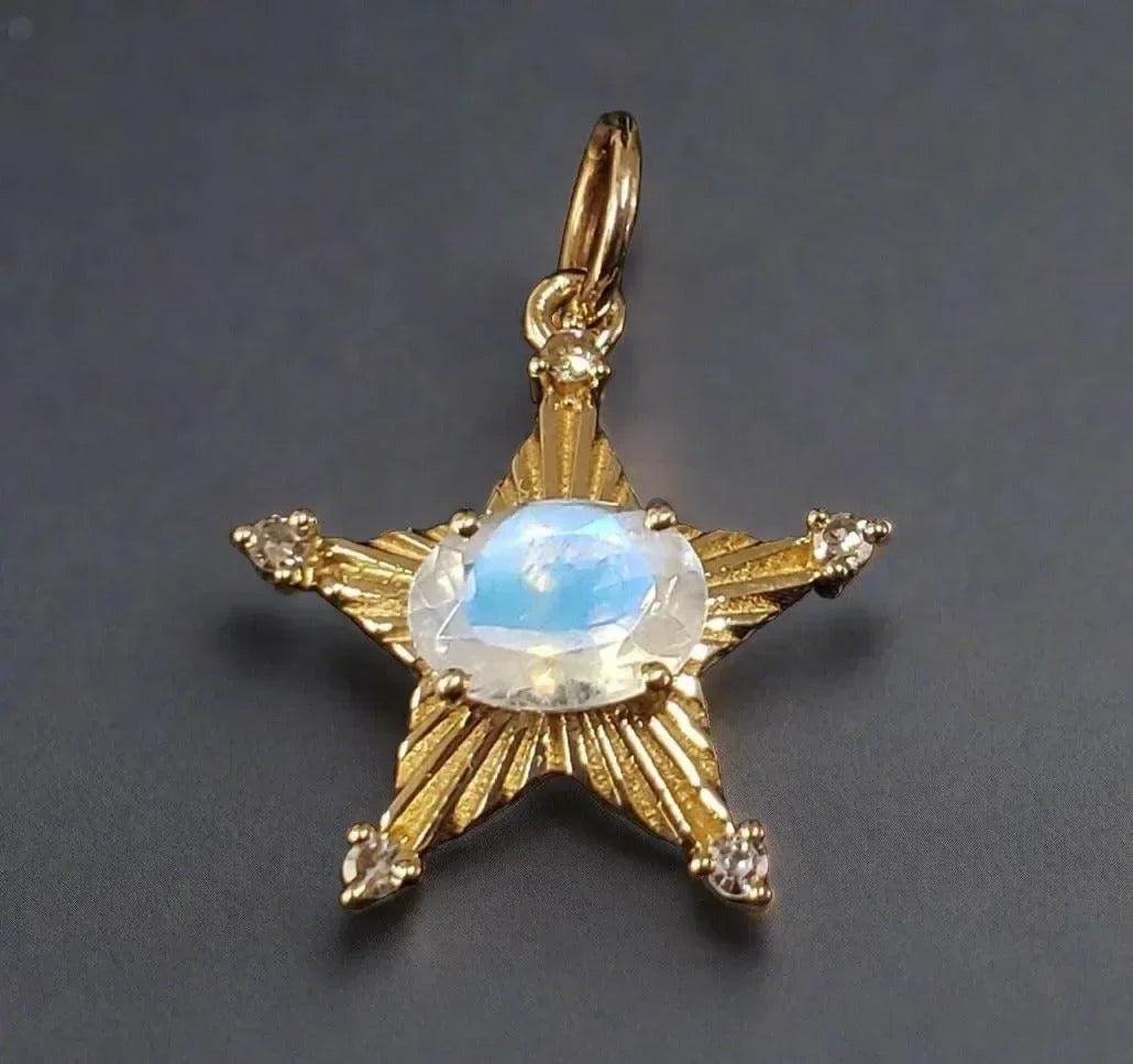 Gold star pendant with oval moonstone and diamond accents, elegant jewelry accessory