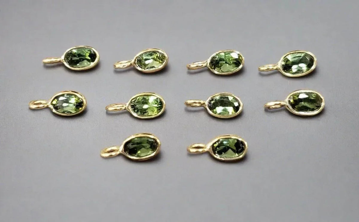 Gold oval pendants with green gemstones, elegant jewelry accessories