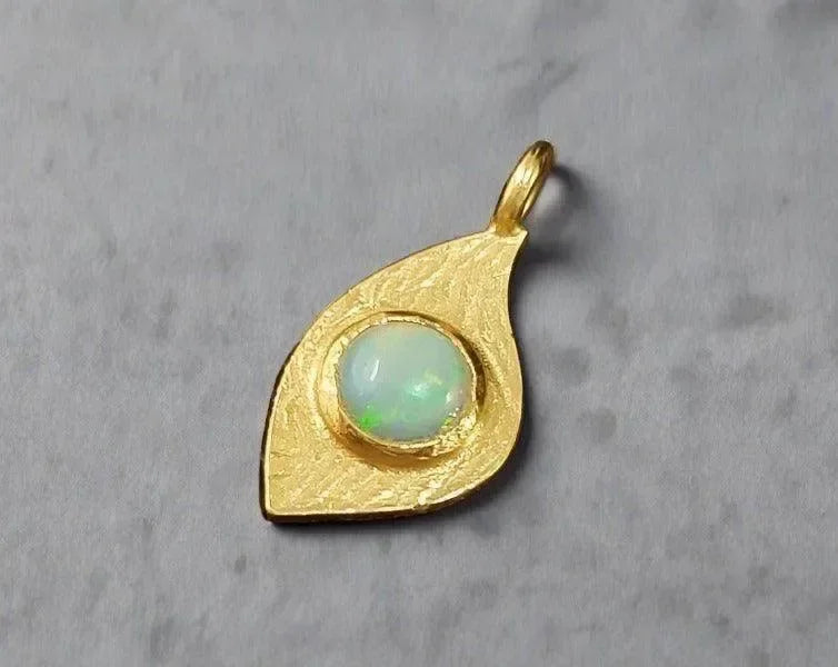 Gold leaf pendant with opal gemstone, elegant jewelry accessory