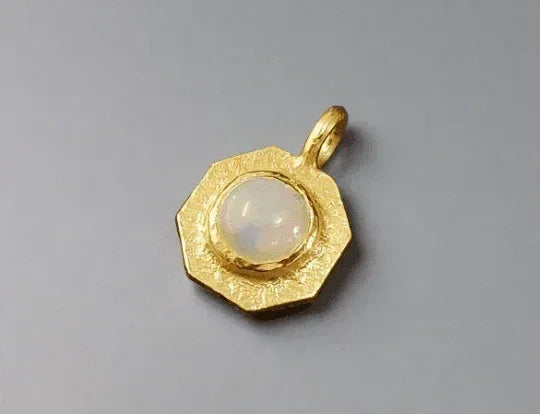 Gold hexagon pendant with opal center, elegant jewelry accessory