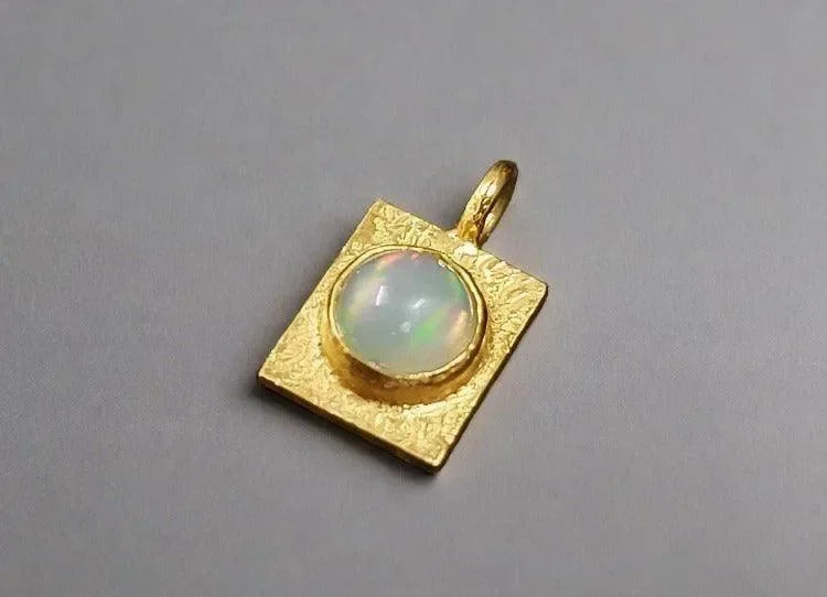 Gold square pendant with opal gemstone, elegant jewelry accessory