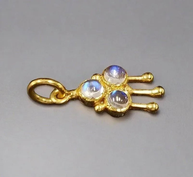 Gold charm with three moonstones, elegant jewelry accessory for necklaces or bracelets