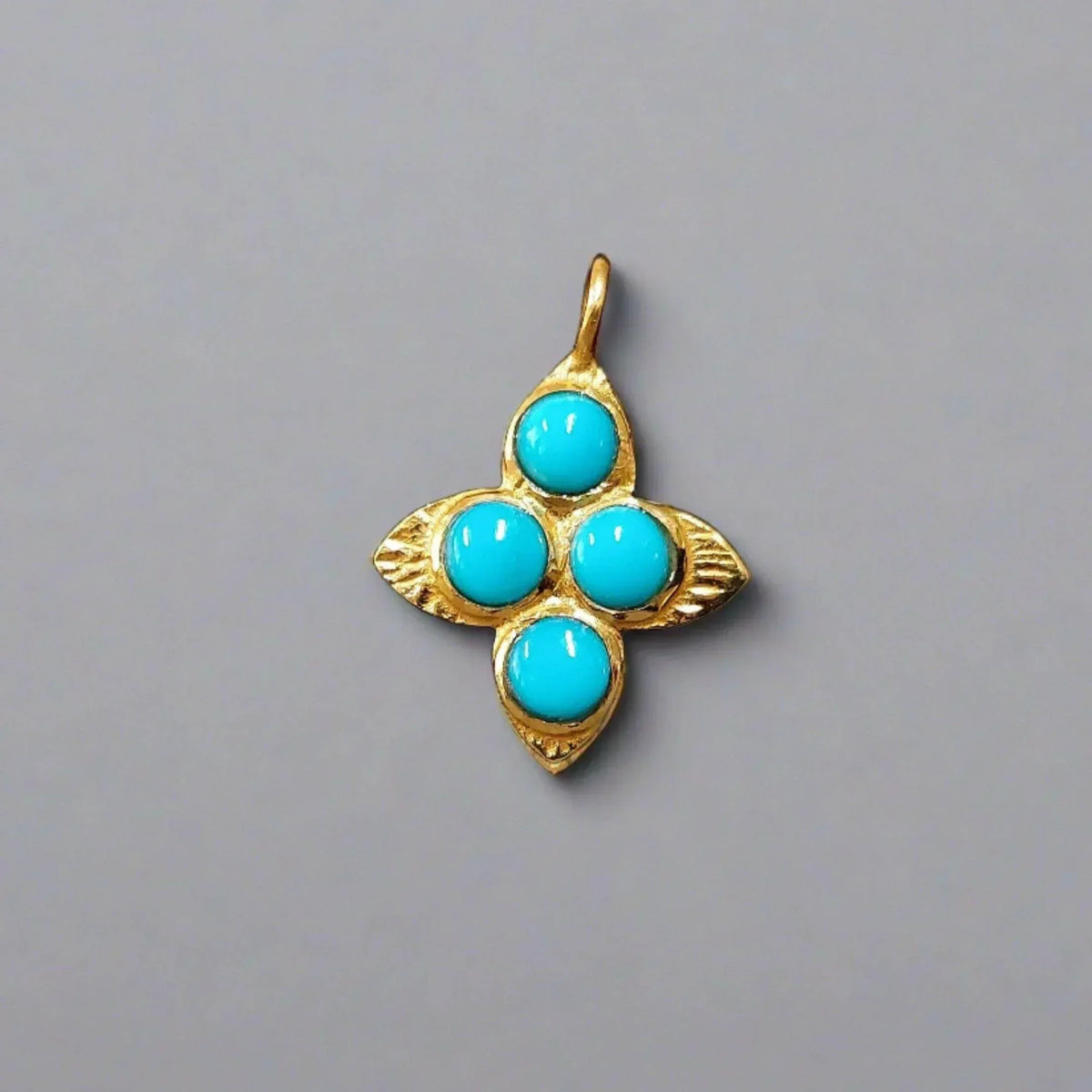 Gold pendant with four turquoise stones in floral design, elegant jewelry accessory
