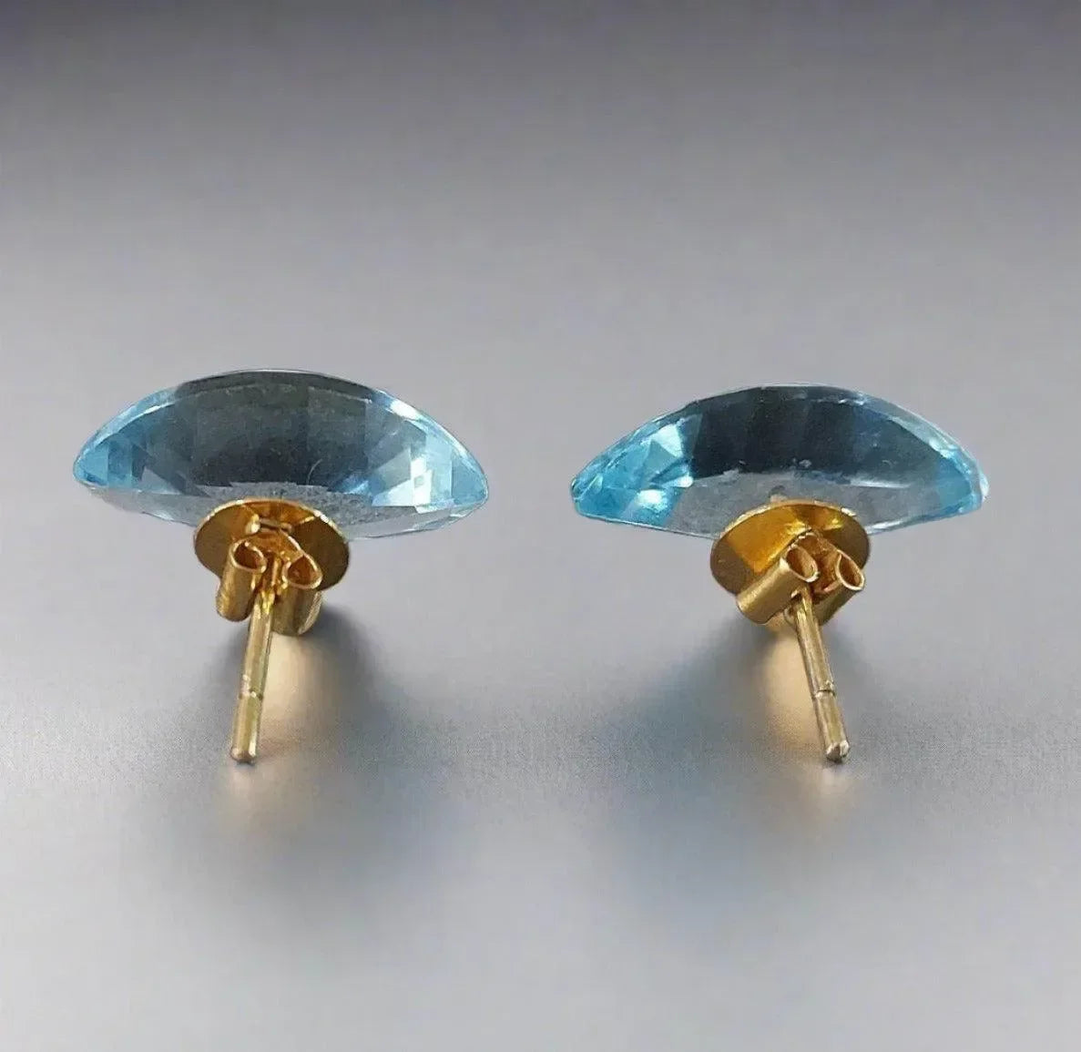 Elegant blue topaz stud earrings in gold setting, perfect for sophisticated jewelry lovers
