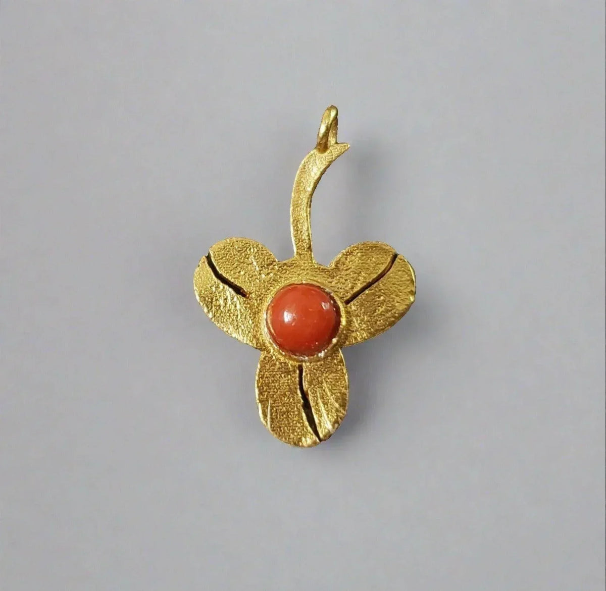 Gold flower pendant with coral center, elegant jewelry accessory