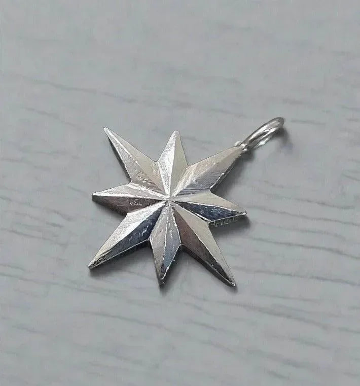 Silver star pendant with textured facets, elegant jewelry accessory for necklaces