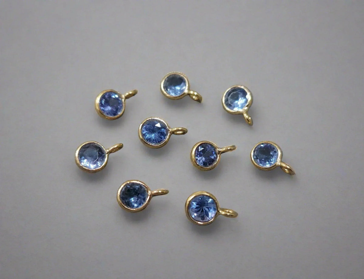 Gold bezel-set blue gemstone charms for elegant jewelry making