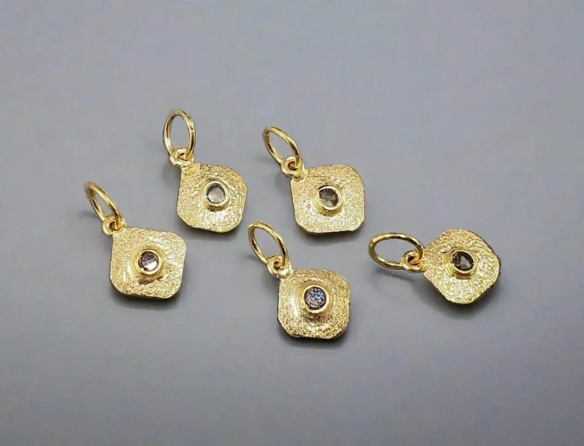 Textured gold square charms with diamond centers, elegant jewelry accessories