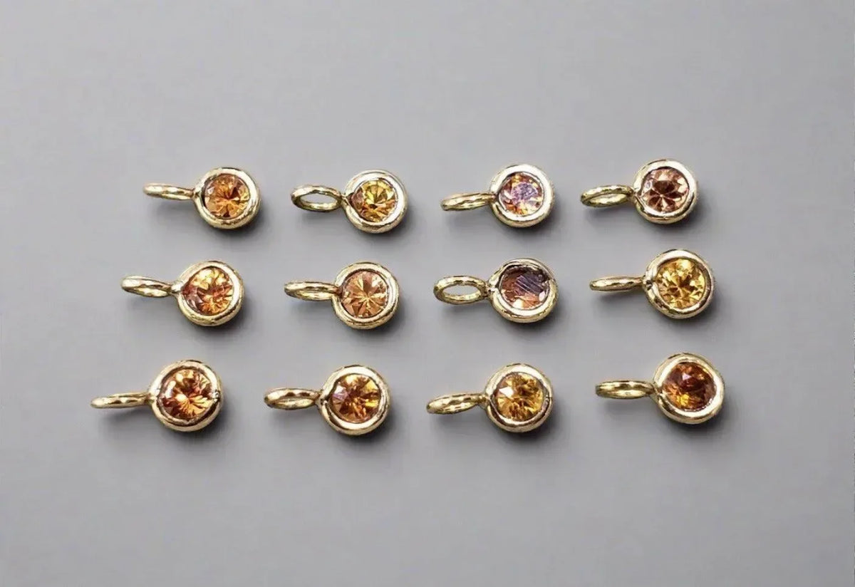 Gold charm pendants with round citrine gemstones, elegant jewelry accessories for necklaces or bracelets