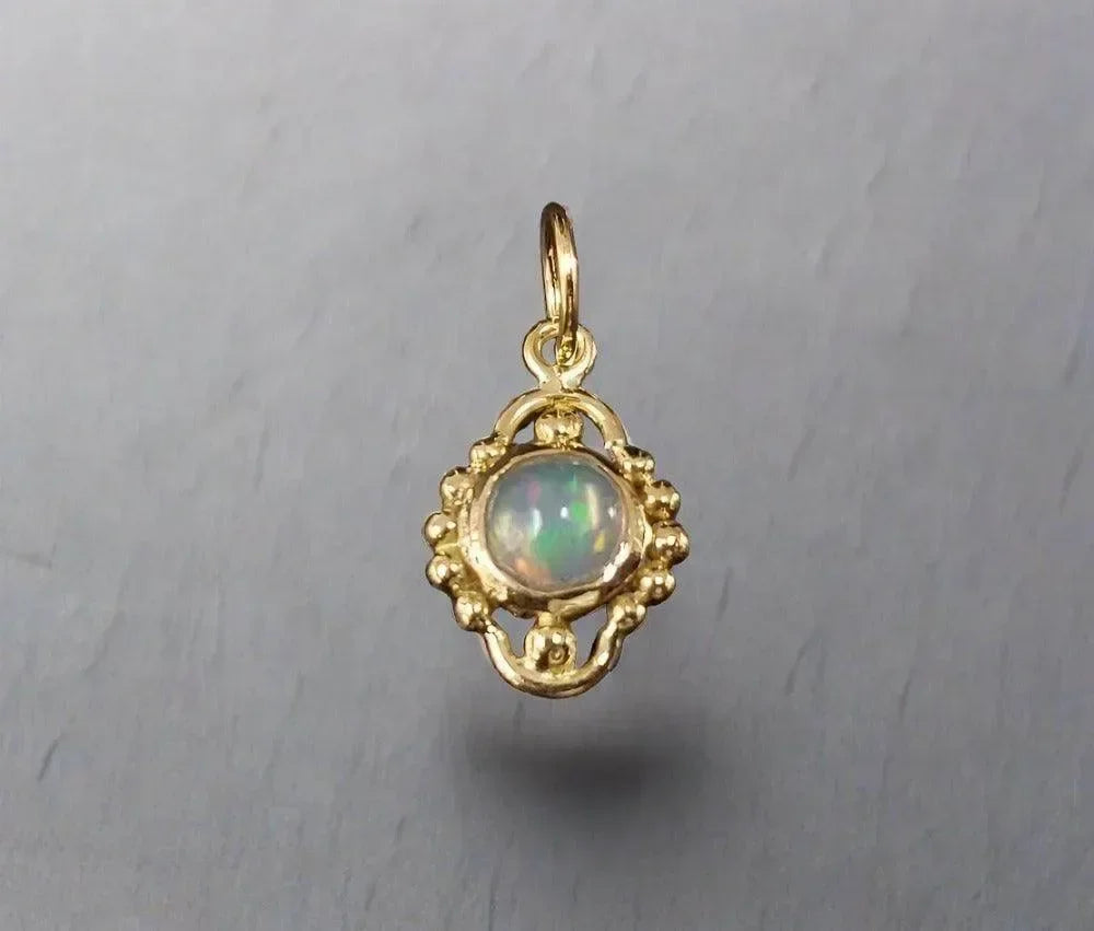 Elegant gold pendant with opal gemstone, vintage-inspired design for fine jewelry lovers
