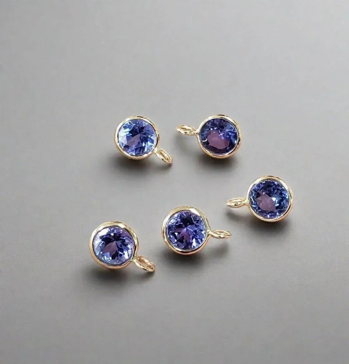 Five gold bezel-set tanzanite gemstone charms for elegant jewelry making