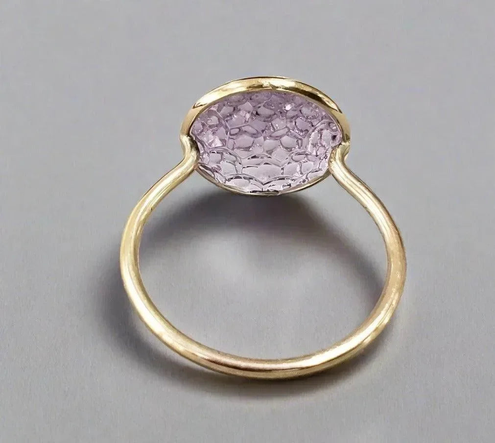 Elegant gold ring with oval lavender gemstone, sophisticated jewelry accessory